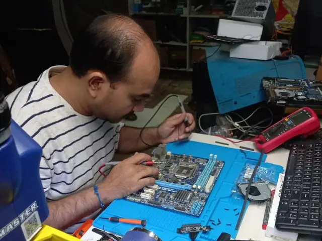 Technician probing a computer motherboard with a multimeter and soldering iron